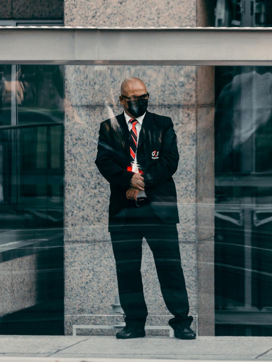 Security professional standing in an urban environment.