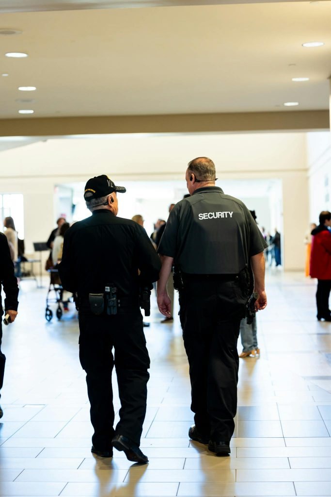 Security guards walking indoors while ensuring safety.